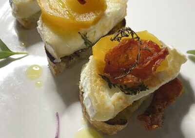 crostini topped with warm goat cheese, shaved beet and sun-dried tomato