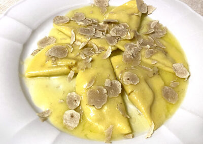 Ravioli stuffed with squash, topped with just-shaved white truffle